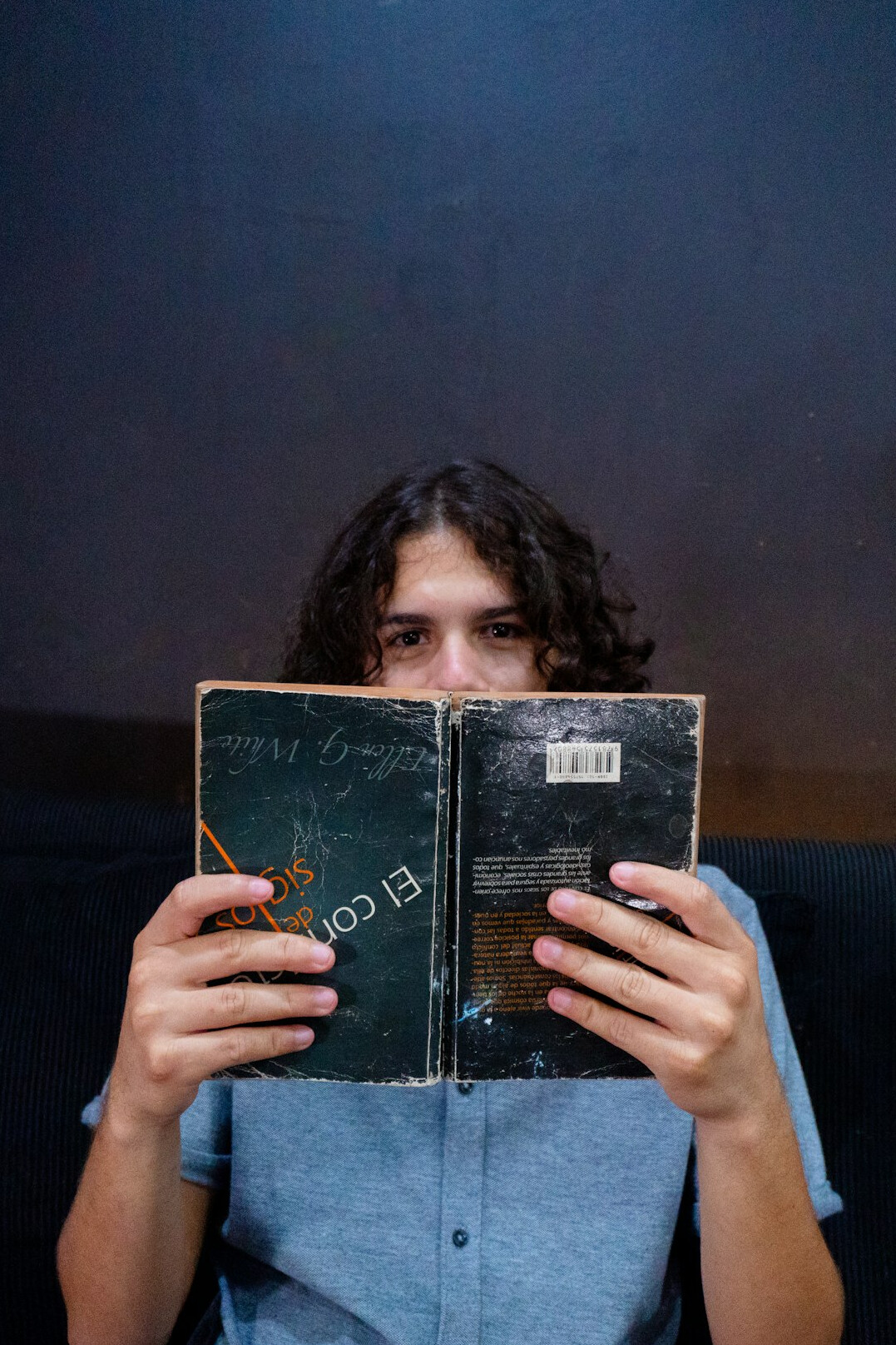 Retrato de una lectora uruguaya sonriendo con un libro de misterio